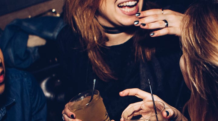 Woman laughing with a cocktail