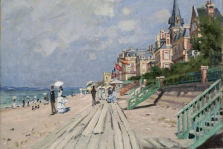 Monet painting of a boardwalk between the beach and a city