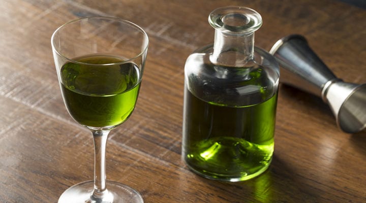 Small glass and bottle of absinthe
